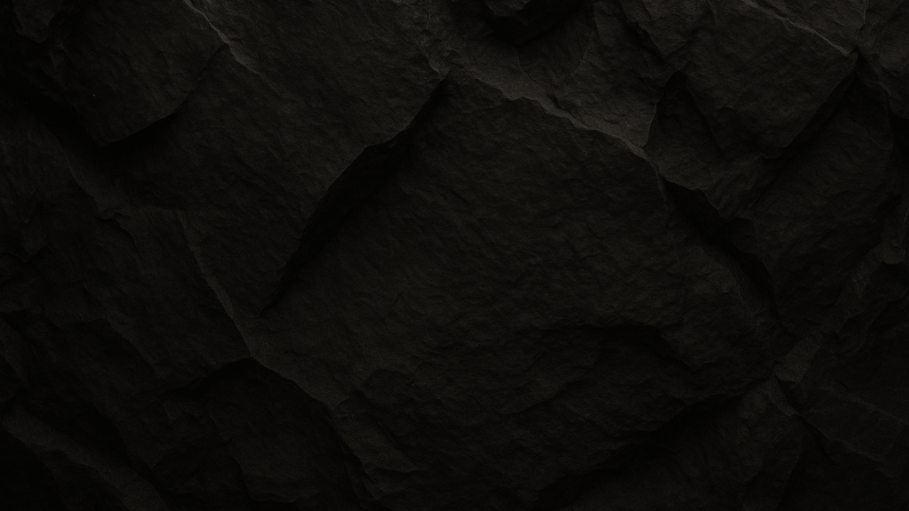 Dark, textured black paper with crumpled surface